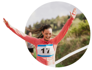 Runner with number 17 crossing finish line with arms raised in celebration