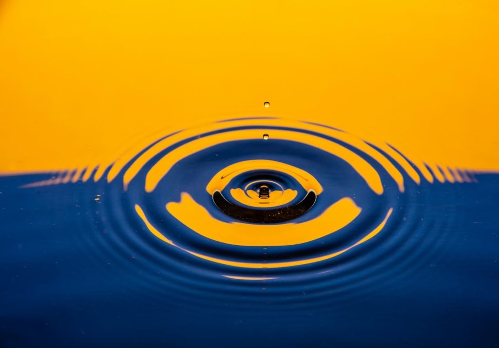 A ripple of water in blue and orange tones