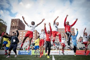 A group of footballers jumping for joy after representing England in the Homeless World Cup