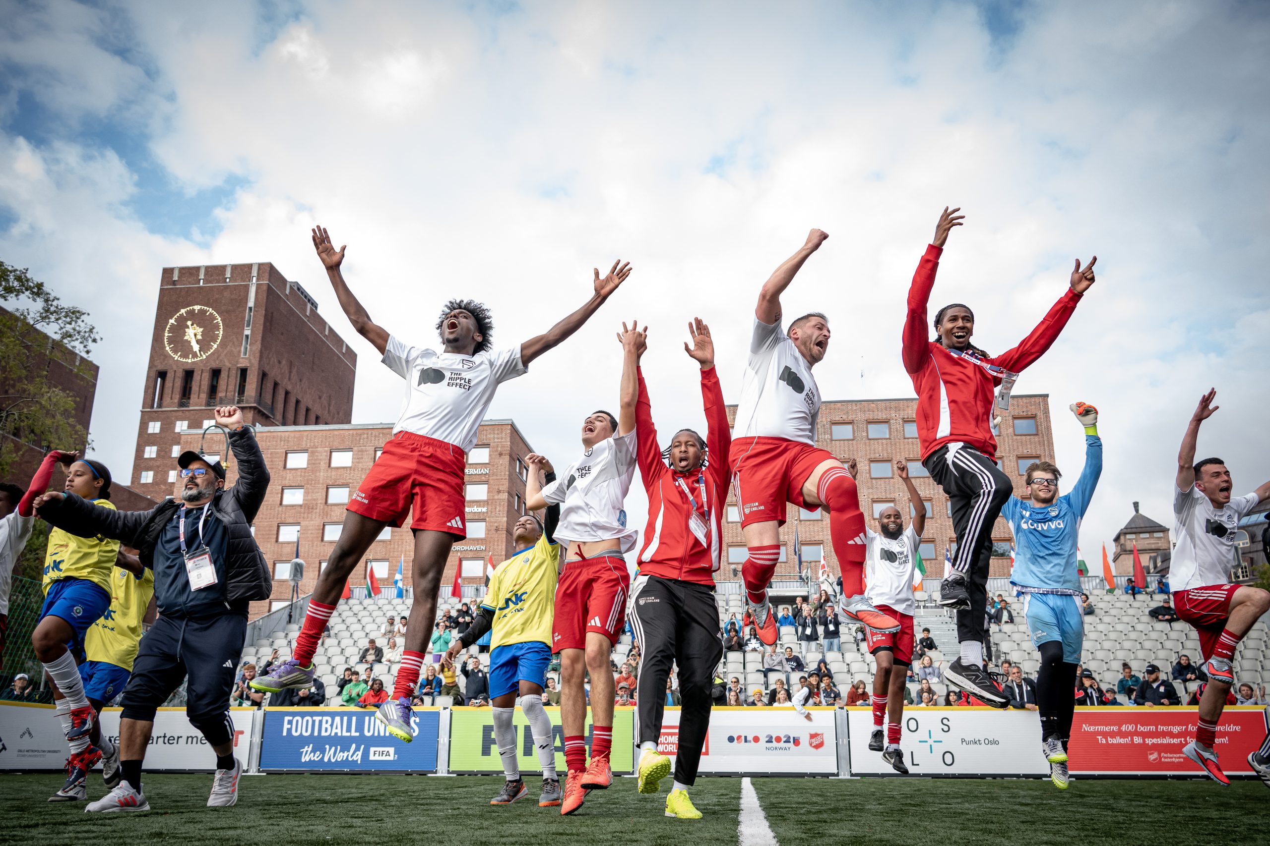 A group of footballers jumping for joy after representing England in the Homeless World Cup